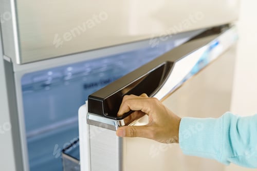 Preview: young woman hand opening refrigerator door