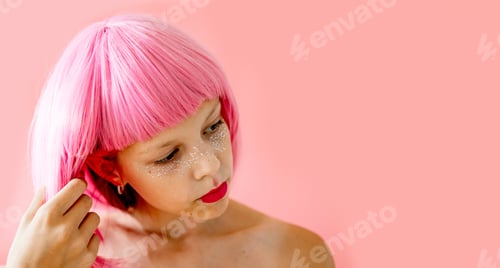 Preview: emotional portrait of teenage girl in a pink wig with pink lipstick stands on a pink background, con
