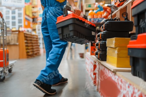 Preview: Builder with toolbox at the shelf, hardware store
