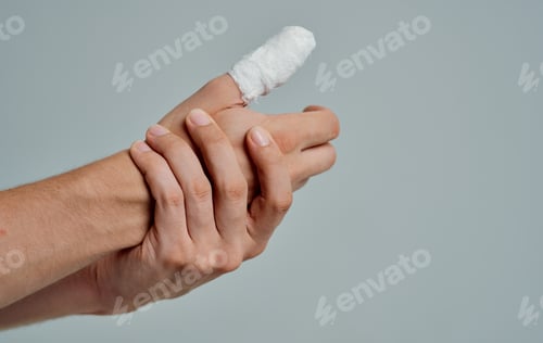 Preview: man in white t-shirt broken finger bandaged medicine