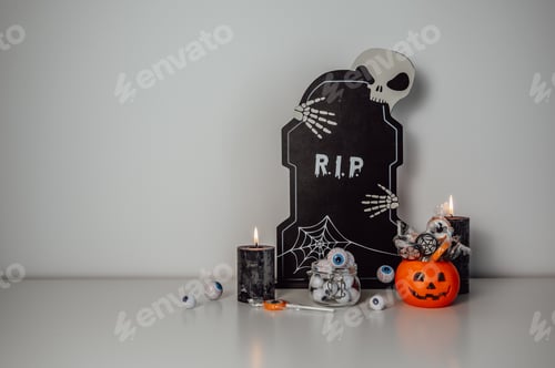 Preview: Moody halloween background with candles, candies and other decorations. trick or treat concept. copy