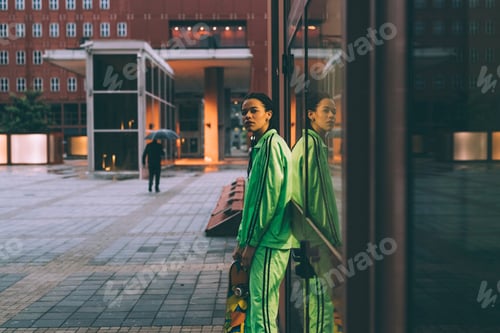 Preview: Woman leaning against glass window, Milan, Italy