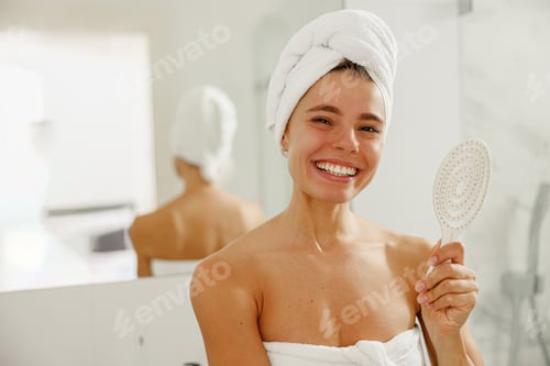 Preview: A smiling woman in a towel before a mirror reflects beauty, confidence, joy, and care