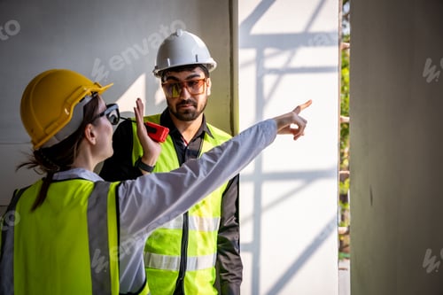 Preview: Engineer inspect building structure technicians looking at analyzing unfinished construction project