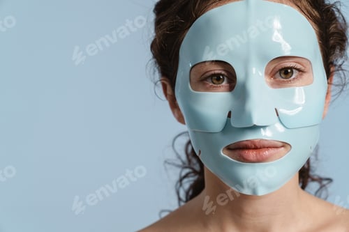 Preview: Beautiful half-naked nice girl posing with facial mask