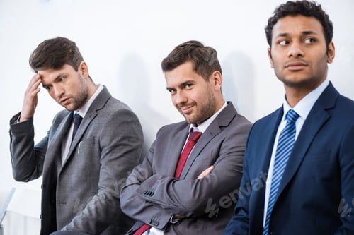 Preview: businessmen sitting in queue and waiting for interview in office, business concept