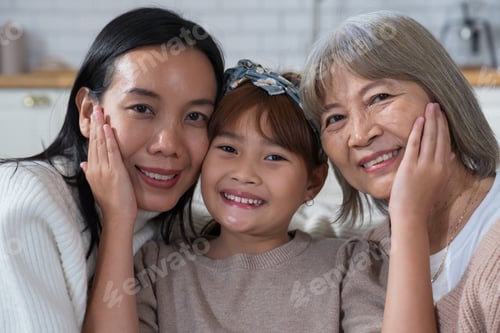Preview: Little girl hugging mother and grandmother, enjoying family time at home