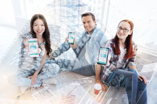 Preview: Delighted Coworkers Demonstrating Mobile Phones To You
