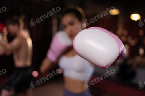 Preview: Portrait of woman learning Muay Thai to build up the strength of the body