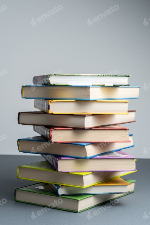 Preview: Stack of colorful books isolated on gray background. Collection of various books. School and educati