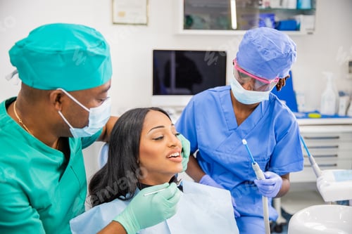Preview: An African woman during a dental visit receives a dental cleaning