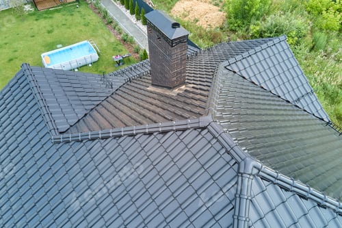 Preview: Closeup of house roof top covered with shiny ceramic shingles