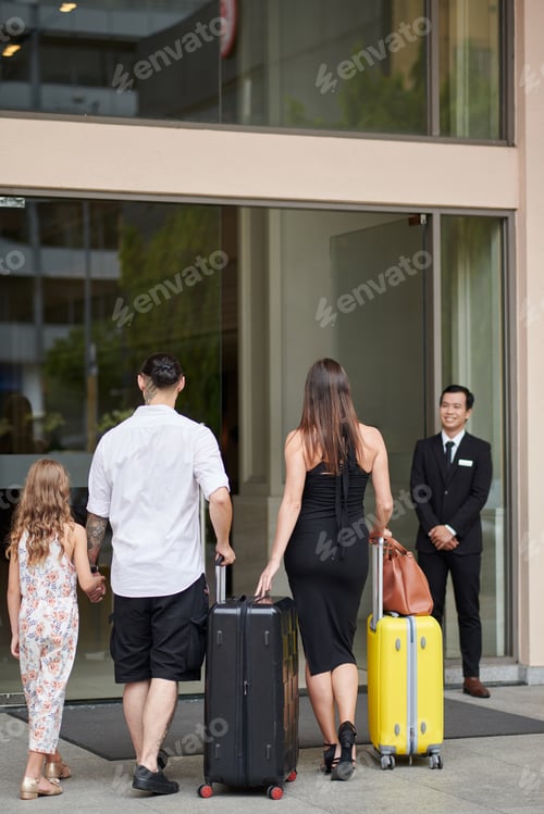 Preview: Family Walking to Hotel Entrance
