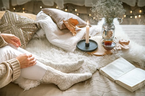 Preview: Cozy autumn at home, a woman with tea and a book.