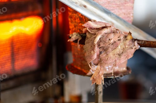 Preview: Closeup detail view of Turkish Doner, chef is slicing the doner