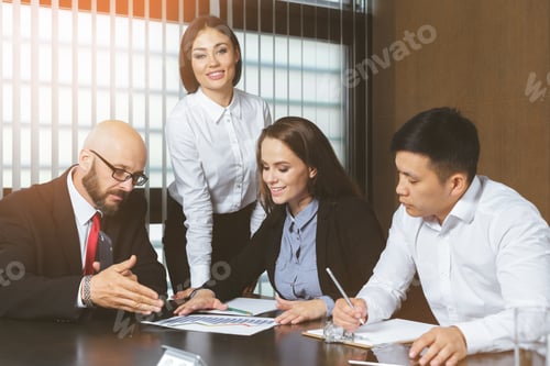 Preview: Group discusses project details in office setting during work hours