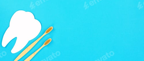 Preview: White tooth and wooden toothbrush on a blue background. Dental care concept, banner, copy space