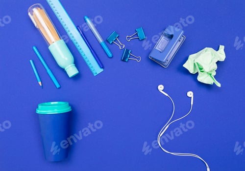 Preview: School and office supplies lie neatly on a blue background