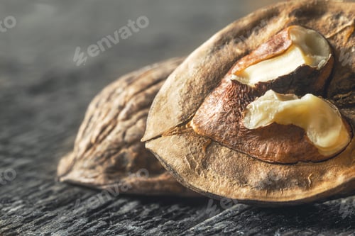 Preview: Walnut on the wooden table close-up