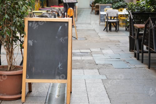 Preview: Empty wooden blackboard mockup standing outdoors in front of cafe