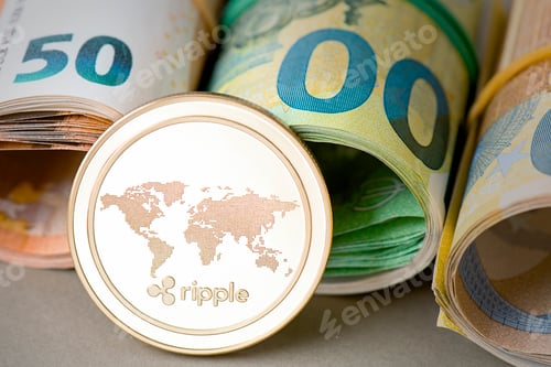 Preview: Cryptocurrency golden Ripple coin on the background of rolled euro bills.