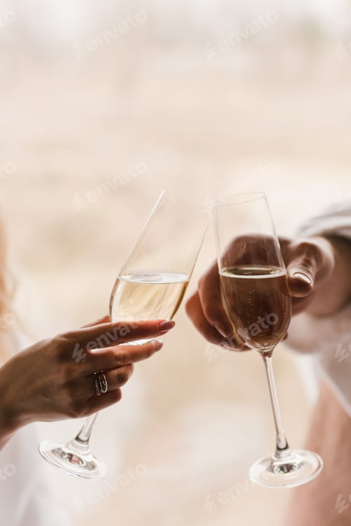 Preview: Caucasian bride and a groom holding hands, wearing wedding rings on their fingers.