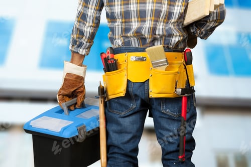 Preview: Worker carries tools in a toolbox while preparing for a project at a construction site
