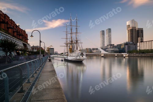 Preview: A serene harbor with a majestic tall ship at sunrise