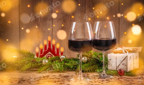 Preview: Crystal glasses of red wine and Christmas gifts on the background of Christmas lights, holiday
