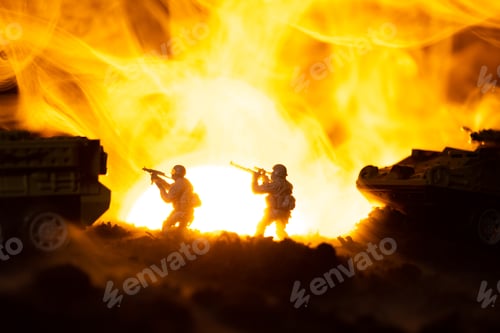 Preview: Silhouettes of toy warriors with tanks in fire and sunset at background, battle scene