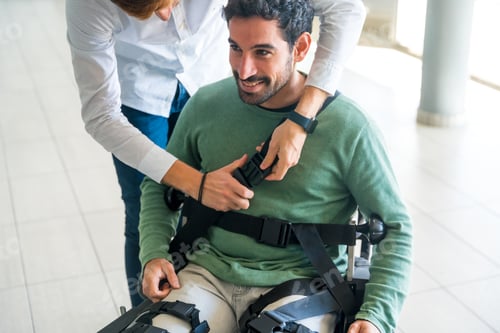 Preview: Mechanical exoskeleton, physiotherapist placing the tapes on the legs the disabled robotic skeleton
