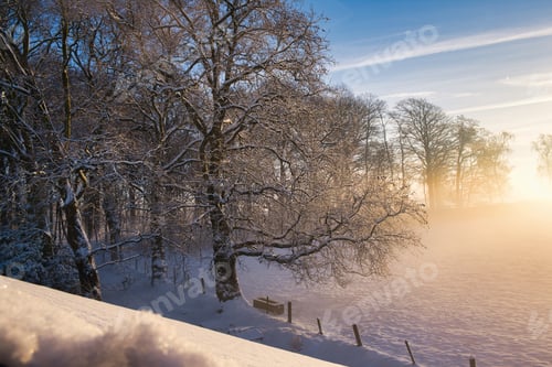 Preview: Scenic view of a field covered with snow at sunset in Maransart, Belgium