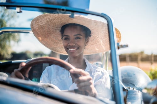 Preview: Black woman driving a vintage convertible car