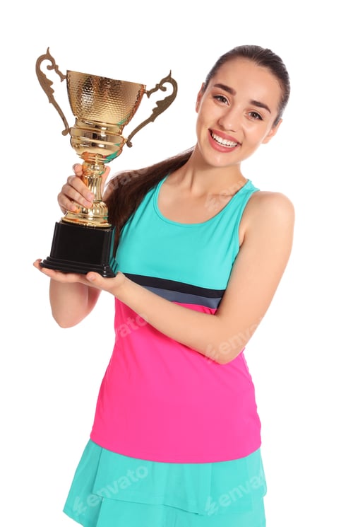 Preview: Portrait of happy young woman in tennis dress holding gold trophy cup on white background