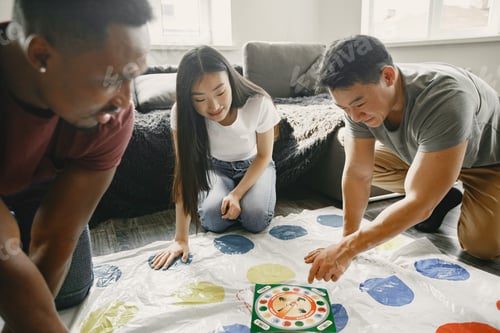Preview: Three friends playing twister in the living room