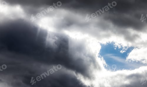 Preview: Dramati Dark Clouds in the Sky with Sunrays.