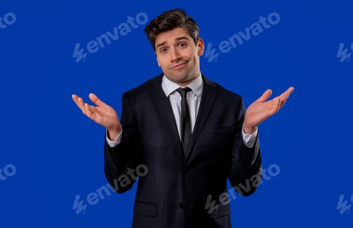 Preview: Shrugging Man in Dark Suit Against Blue Backdrop