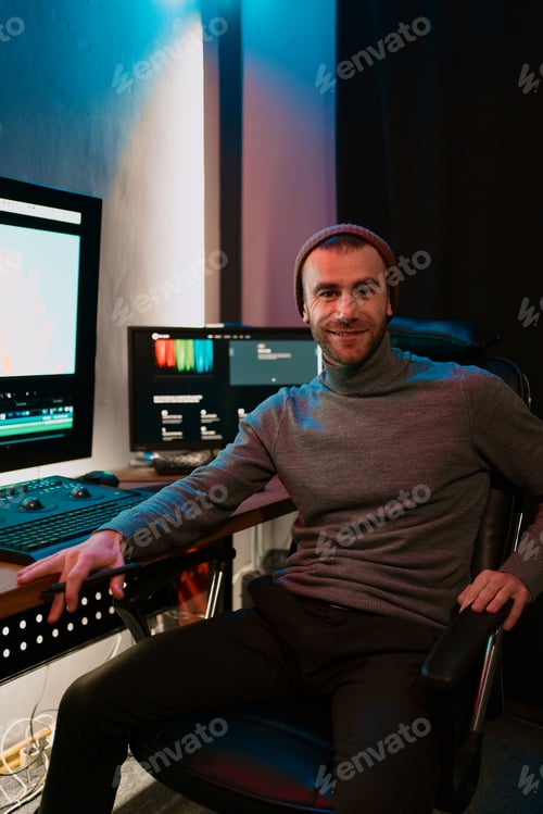 Preview: Male Video Editor Working on His Personal Computer with Big blank Display