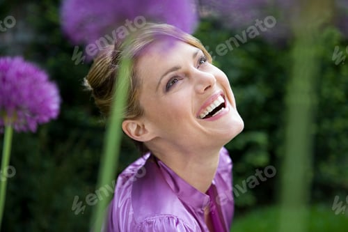 Preview: Carefree woman amongst allium flowers