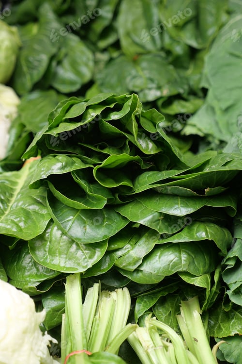 Preview: A Vibrant Display of Fresh Spinach and Greens at the Local Marketplace