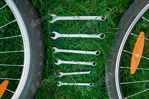 Preview: Tools, instrument for repairing bike on the wooden background outdoor wheel. Bicycle repair.