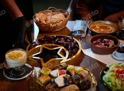 Preview: In this captivating aerial view, delicious food adorned with Ramadan decorations, including dates