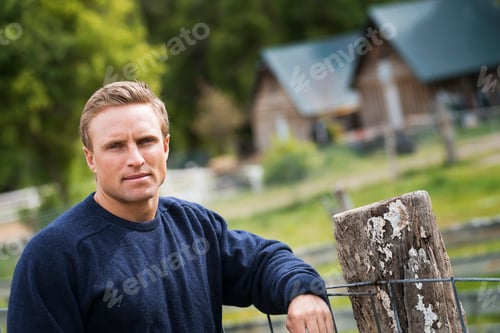 Preview: A man with a blue jumper at home on his property.