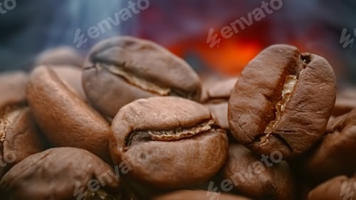 Preview: Close up of seeds of coffee. Fragrant coffee beans are roasted smoke comes from coffee beans.