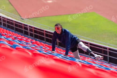 Preview: Disabled athletes prepare their bodies on amphitheater in a sports arena on a sunny day