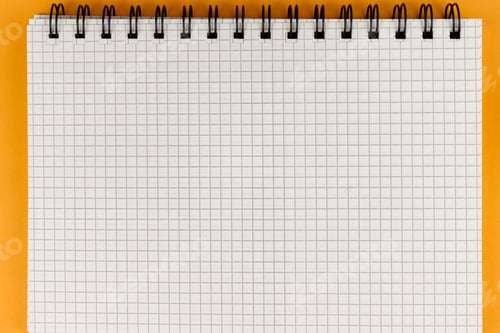 Preview: Notebook with school supplies on orange background
