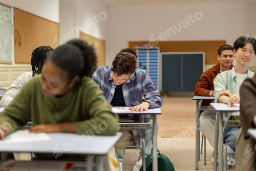 Preview: Diverse high school students studying in classroom