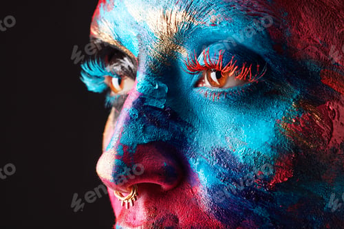 Preview: Cropped shot of an unrecognisable woman posing alone in the studio with paint on her face