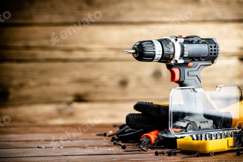 Preview: Drill and Tools on a Wooden Background
