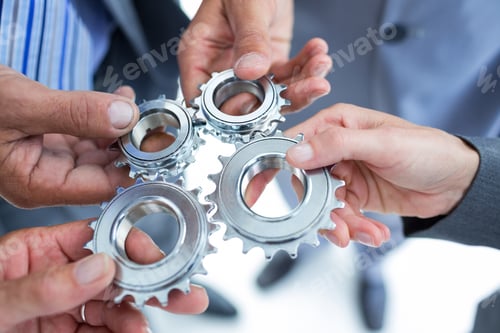 Preview: Business Colleagues Holding Cog In The Office